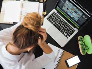 Stressed out woman sitting at laptop